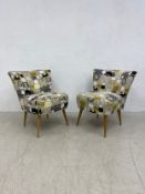 A pair of contemporary retro styled salon chairs on tapering beech supports. H.78cm