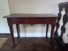 A Georgian mahogany side table having a rectangular top over two short frieze drawers raised on