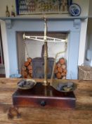 A late 19th century set of brass beam scales complete with pans, chains and a selection of weights