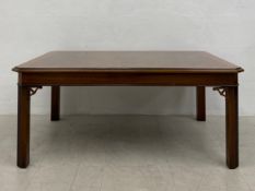 A mid Georgian style walnut and crossbanded coffee table on canted square section supports. H.46 W.