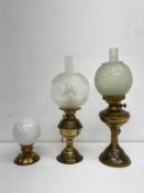 Three brass oil lamps wired for electricity. H.56cm