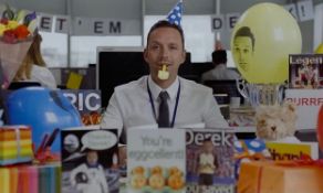 A large contemporary print depicting an office worker with party hat surrounded by cards, framed and
