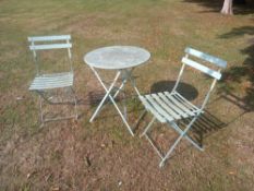 A pair of folding metal garden chairs and a matching table. Dia. 60cm. ** Please note this item