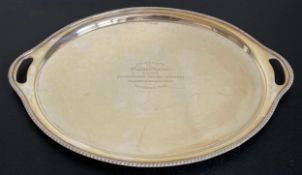 A silver twin handled tray of oval shape with gadrooned edge hallmarked Walker and Hall Sheffield