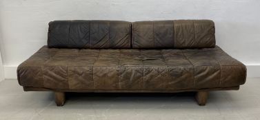 A vintage sofa in the manner of De Sede upholstered in tan leather. 67x198x98cm