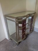 A 20th century Venetian style mirrored chest of drawers having a break-front top with reeded edge