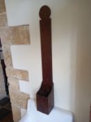 A 19th century wall mounted Welsh knife sharpening board with crudely carved circular finial and