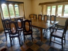 A set of ten carved teak Carolean style dining chairs with caned backs and seats on barleytwist