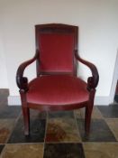 A 19th century mahogany French Empire armchair with scrolling arms on sabre supports. H.95cm (Some