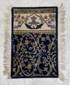 A small 20th century Persian style rug having all-over scrolling foliate decoration over a