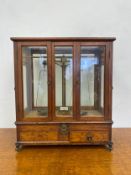 A set of late 19th century beam scales in a glazed oak case fitted with frieze drawers. 48x43x23cm