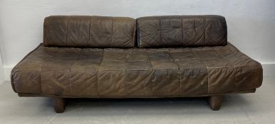A vintage sofa in the manner of De Sede upholstered in tan leather. 67x198x98cm.