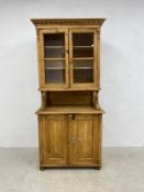 A 19th century Continental pine two section dresser or bookcase with glazed upper section above base