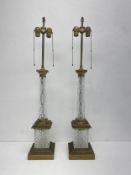 A pair of large Hollywood Regency style cut glass and brass double bulb table lamps by Warren