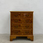 A contemporary Georgian style yew-wood chest of drawers of small proportions having a rectangular