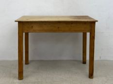 A C.1900 pine side or kitchen table having a rectangular top raised on straight square section
