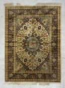 A Tabriz rug with central medallion on a biscuit ground within flowerhead spandrels and multiple