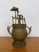 A Ghana Ashanti kuduo with figural decoration to the lid and handles. H.28cm