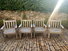 A set of four teak garden armchairs. W.60cm (One with slight damage as seen). ** Please note this