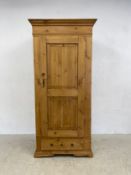 A 19th century pine hall cupboard with single panel door enclosing hanging space above base