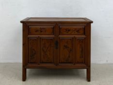 A Chinese hardwood side cabinet with fitted interior and hand painted bird and flower decoration.