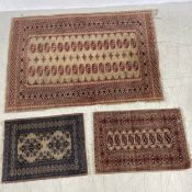 A Bokhara rug along with two smaller examples. 179x125cm (largest)
