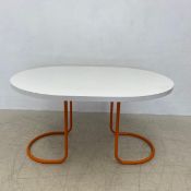 A mid-century dining table with composite laminated top on tubular metal base. H.72 L.136 W.102cm.