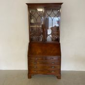 A Georgian style mahogany two section bureau bookcase with glazed upper section above fall front