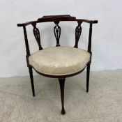 A late 19th century rosewood corner chair in foliate damask upholstery on slender cabriole supports.