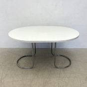 A mid-century dining table with composite laminated top on tubular metal base. H.72 L.136 W.102cm.