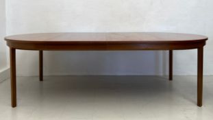 A mid-century teak extending dining table with two extra leaves. H.72 W.245 D.125cm (extended) H.