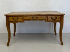 A 19th century style walnut French Provincial bureau plat or writing table fitted with three drawers