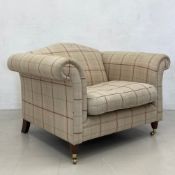 A large Laura Ashley armchair in cheque upholstery on turned tapering mahogany supports