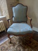 A 19th century French walnut framed fauteuil armchair having a shaped back and open arms over a