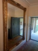 A very large wall mirror in the French 19th century style having a rectangular bevelled plate in