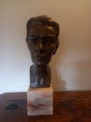 A mid century bronze portrait bust of a woman on a square marble base. H.48cm