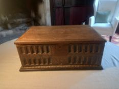 A 17th century oak bible box with foliate carving to front and sides. L.50 H.20 D.32cm
