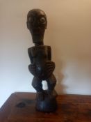 A carved hardwood standing Baule female fertility figure. H.65cm