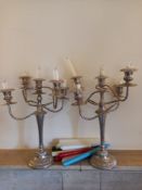 A pair of silver plated five branch candelabras. H.45cm (And some candles).