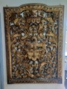A very large early 18th century carved giltwood panel with heraldic crest or coat of arms having a