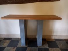 A contemporary teak and sheet metal clad console table the rectangular top on block supports. H.88