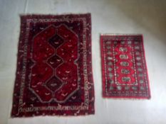 A Shiraz rug with triple medallions on a burgundy ground along with a smaller Bokhara example.