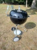 A Weber kettle barbecue with tools. Dia. 58cm