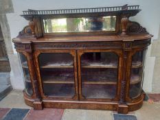 A 19th century burr walnut credenza with carved bevelled mirror back above a pair of glazed doors