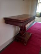 A 19th century French Empire style mahogany tea table having a rectangular foldover top over an