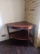 A 19th century mahogany occasional corner table having a bow-front top raised on square tapering