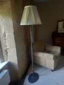 A 20th century naturalistic form standard lamp with pleated shade raised on a circular plinth