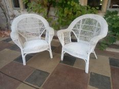A pair of wicker conservatory open armchairs. H.88 W.76cm