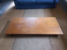 A low coffee table, teak with metal supports. L.150 W.70 H.13cm.