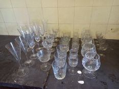 A mixed collection of cut crystal and etched glass drinking glasses. H.21cm